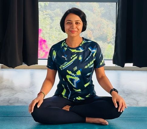 Binita R. Shah seated cross-legged in the studio